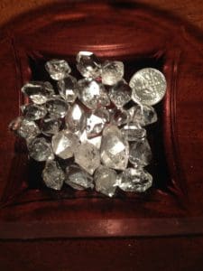 Herkimer Diamonds in a bowl, a dime is included to show they are similar in size.